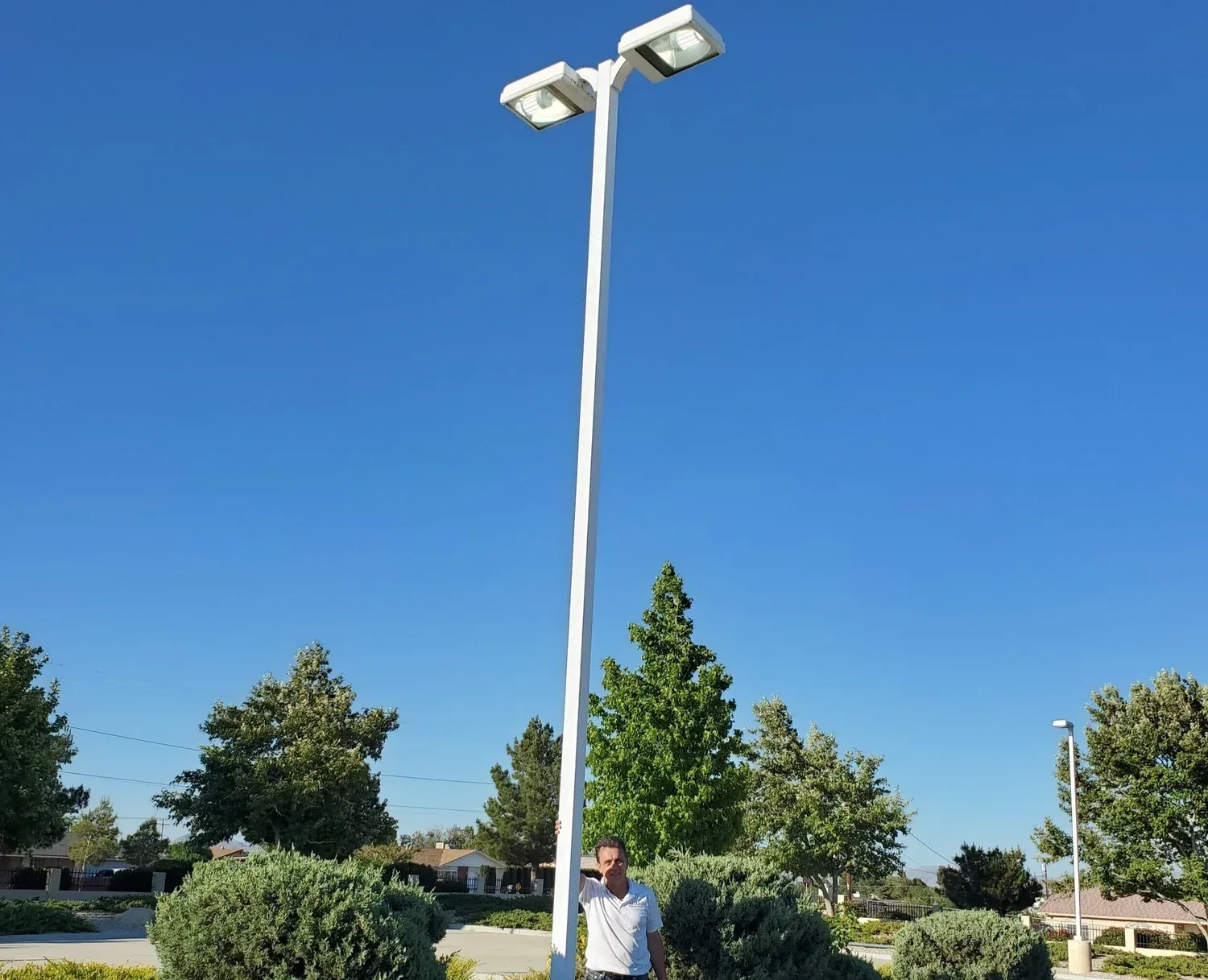 New LED parking lot pole light with a double head against a clear sky