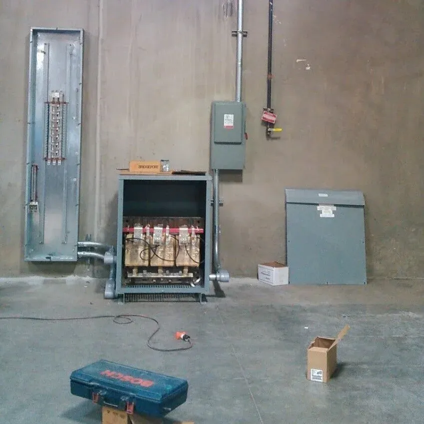 Open transformer enclosure on a commercial job, with tools on the floor